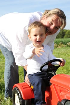 Mother and son with red tractor