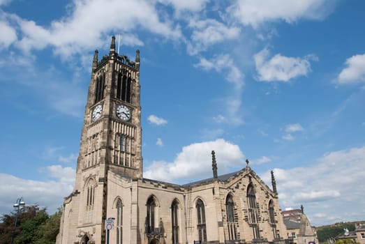 The Parish Church and Clocktower of a Yorkshire Town under a blue sky