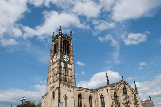 A Church and Clocktower in a Yorkshire Town under a blue sky