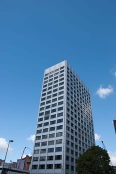 A Grey Coloured Apartment Block under a blue sky