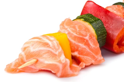 salmon kebab with zucchini and peppers isolated on white background