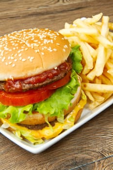 hamburger with potatoes on wooden background