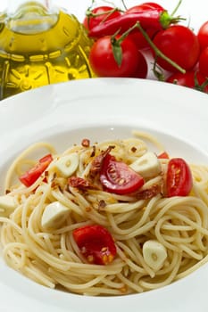 pasta garlic olive oil and red chili pepper closeup on a white dish