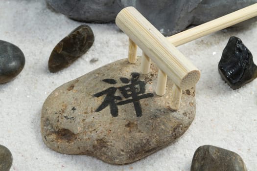 a zen stone on sand background