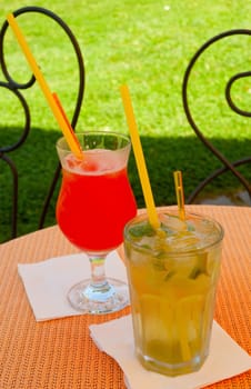 Mojito and Pink Lady Cocktails on the Table in the Garden Restaurant
