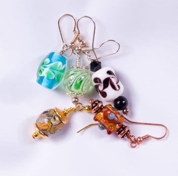 Bead designed earrings made as a hobby and photographed on white cloth