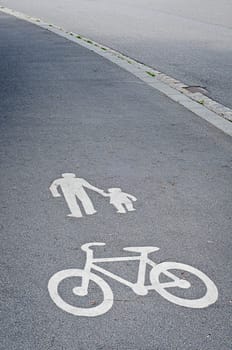 Painted signs on asphalt for pedestrian and bicycle dedicated lane