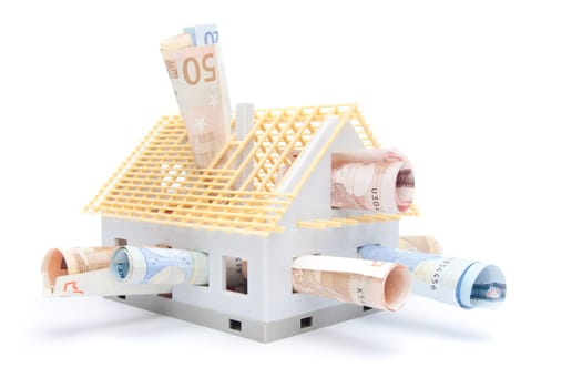 Housing finance, building savings and realty financing (investments) concept. Money and model of the family house.