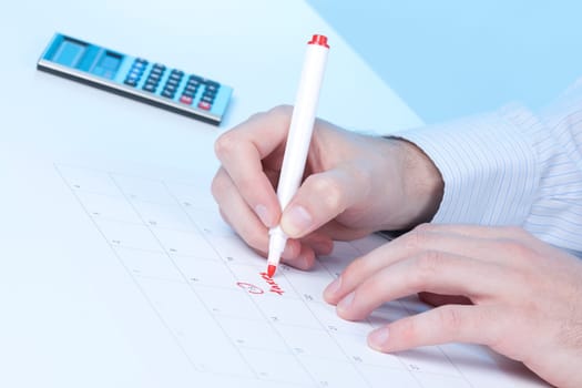 Hand write word taxes into calendar