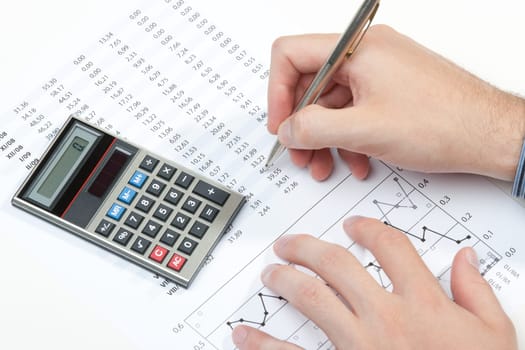 Business analyst working - hand with pen, calculator, sheet and graph