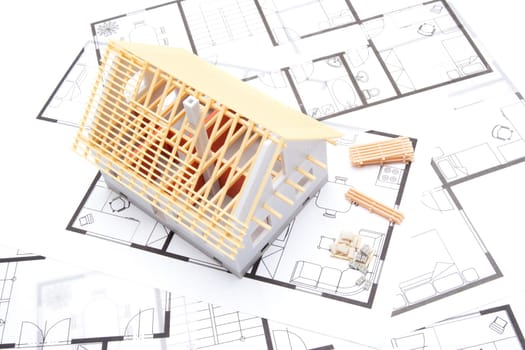 Building the house concept - model of the house with building material and blueprints, top view
