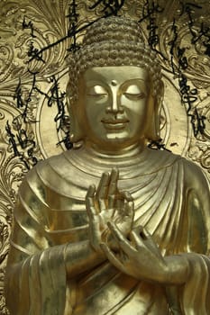 Bronze icon blessing Buddha in serene mood