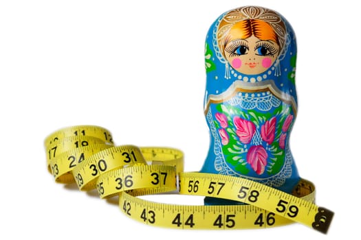 A thin Matrioska doll with a measuring tape around its waist