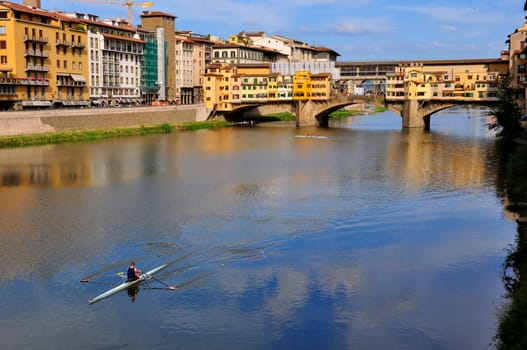 Vecchio Bridge , Florence , Italy, with rower passing by