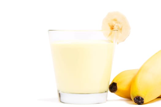 Bananas milkshake with bananas next to it on white background