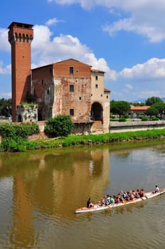 Guelph Tower of the old Citadel , Pisa , Italy, with a rower boat passing by