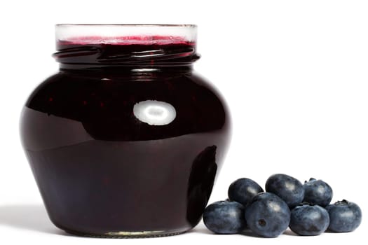 Jam jar with blueberries on white background