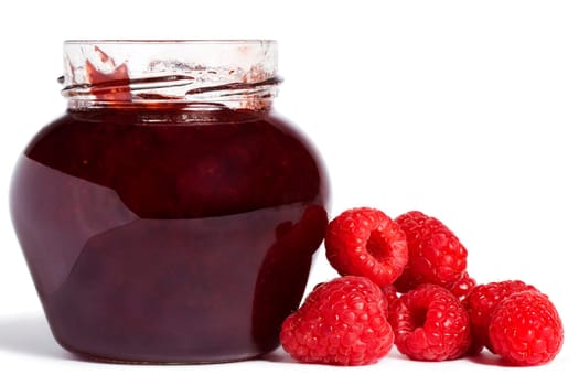 Jam jar with raspberries on white background