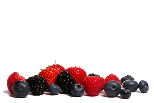 Blueberries,raspberries,strawberries and blackberries mix on white background
