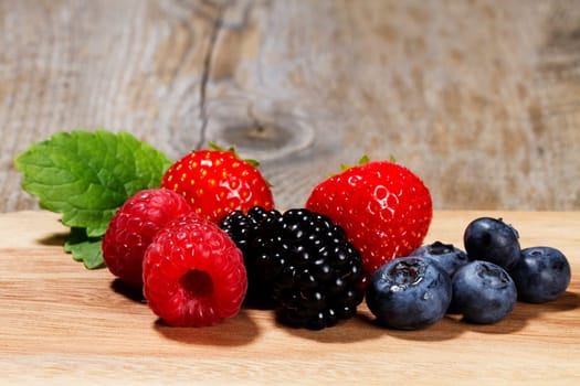 Wild berries on wooden background