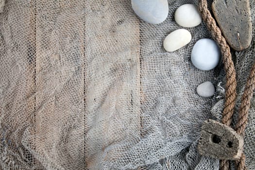 Cork, fishing net and rope with wooden background