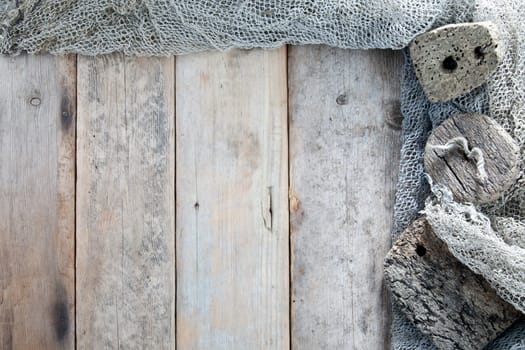 Cork, fishing net and rope with wooden background