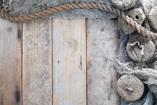 Cork, fishing net and rope with wooden background