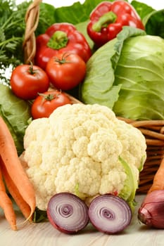 Composition with raw vegetables and wicker basket