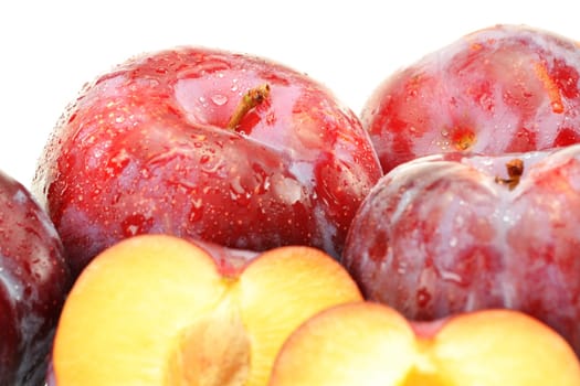 Composition with plums on white background