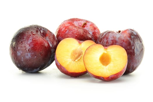 Composition with plums on white background