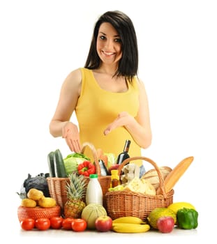 Young woman with groceries in wicker baskets isolated on white.