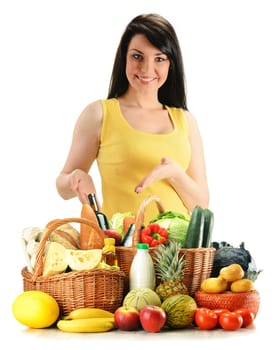 Young woman with groceries in wicker basket isolated on white