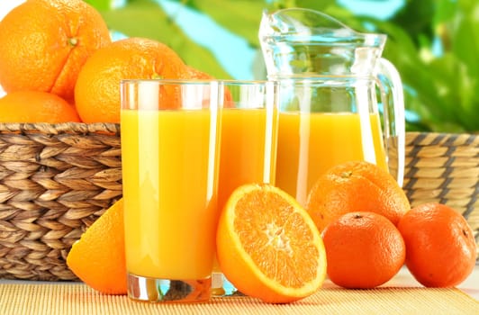 Composition with two glasses of orange juice and fruits