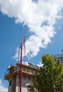 A red Concrete Pump at work on a construction site