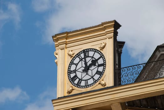 An Antique Gold Coloured Clock on a civic building in an English City