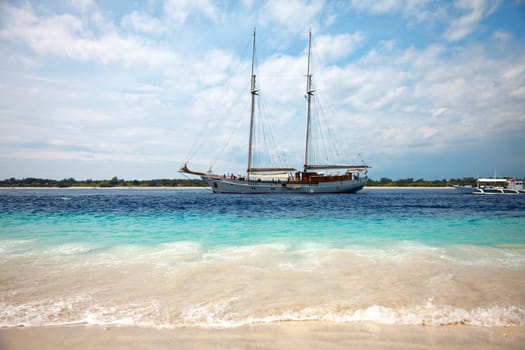 Boat passing through a stunnig blue beach