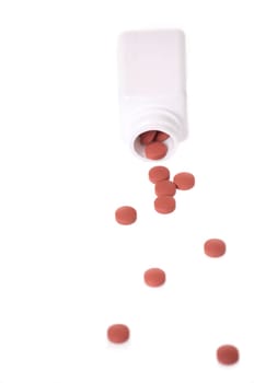 A white pill bottle with red generic pills on a white background.