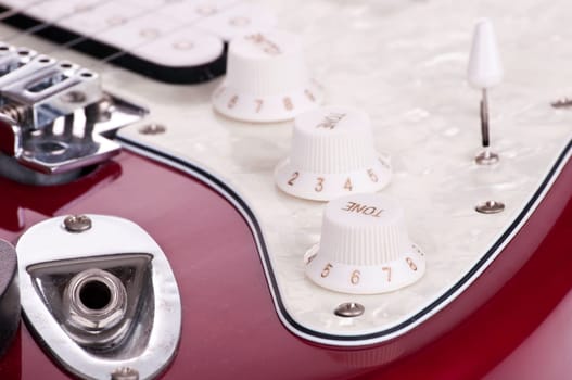 Detail of electric red and white guitar