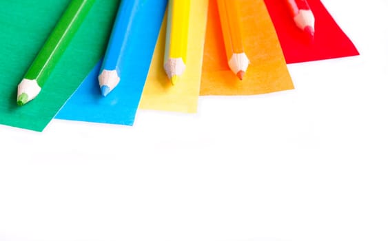 A colorful pencil crayons and scrapbooking papers ready for creative use.