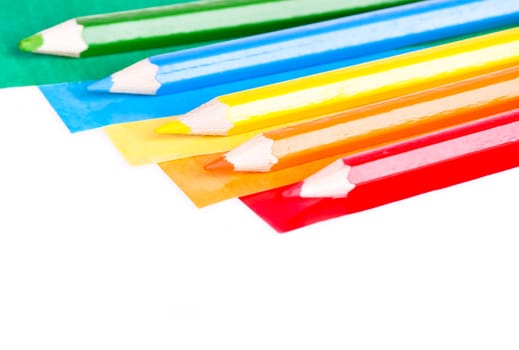A colorful pencil crayons and scrapbooking papers ready for creative use.