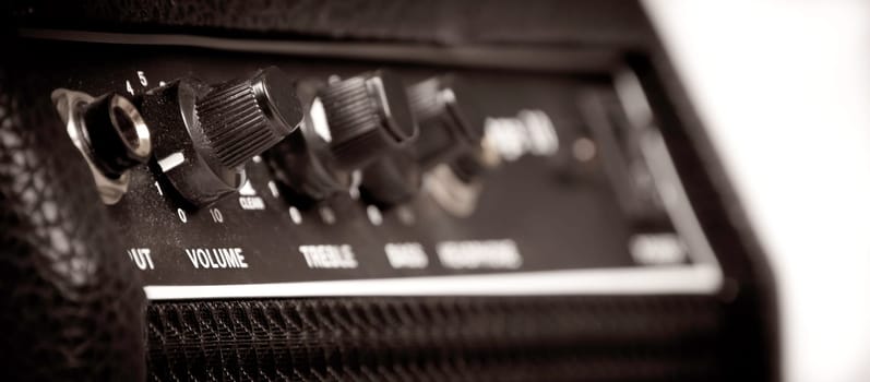 Knobs of different functions on a guitar amp