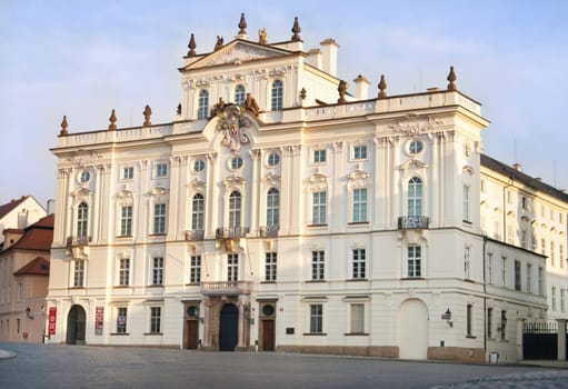 the white prague palace outside of the castle front gate