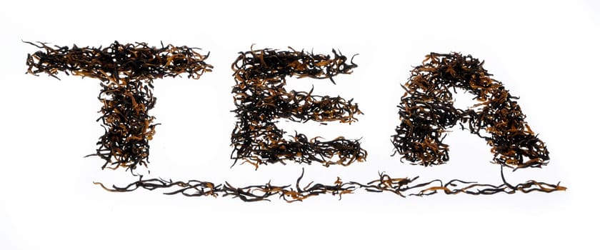 The word tea written using black oolong tea from china on isolated background