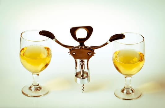 Glass of white wine and corkscrew isolated on a white background