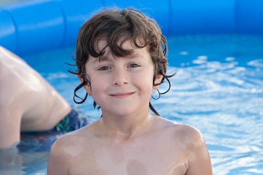 Adorable little boy swiming in the swimming-pool
