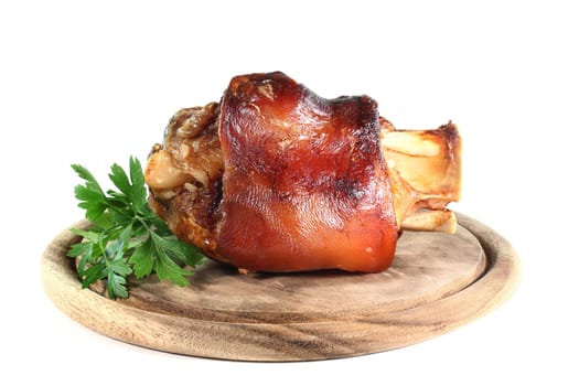 grilled pork knuckle in front of a white background