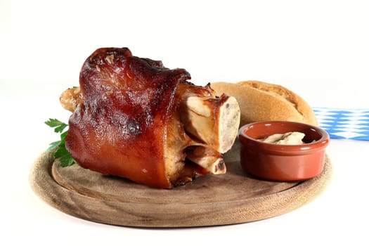 grilled pork knuckle in front of a white background