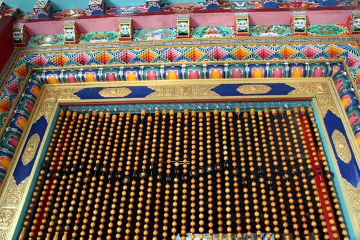 A beautifully designed door frame and beaded curtain