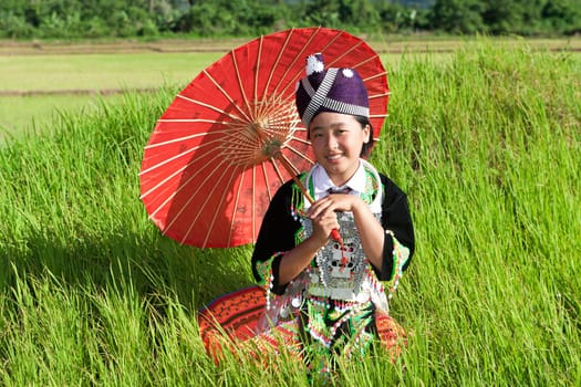 Portrait of Hmong of Laos,with parasol and traditional costume