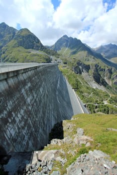 Side of Grande Dixence dam by cloudy but sunny weather, Switzerland